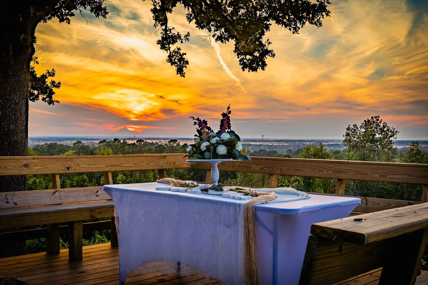 Flowers on a table for two against the sunset