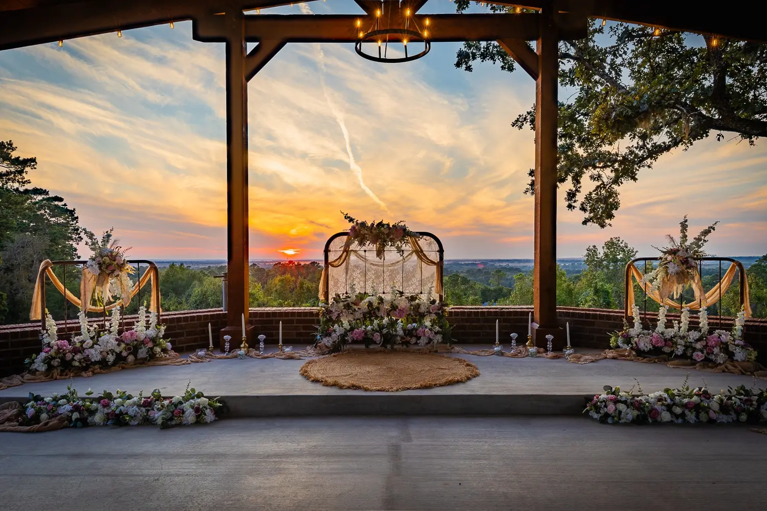 A floral ceremony setting overlooking the sunset